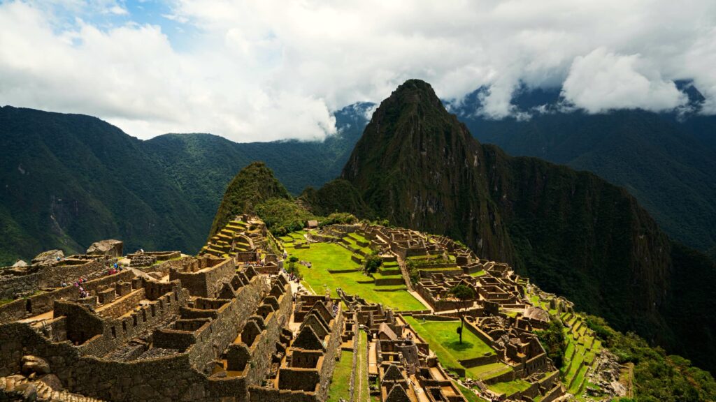 A breathtaking view of Machu Picchu with its ancient ruins and the towering Huayna Picchu mountain in the background