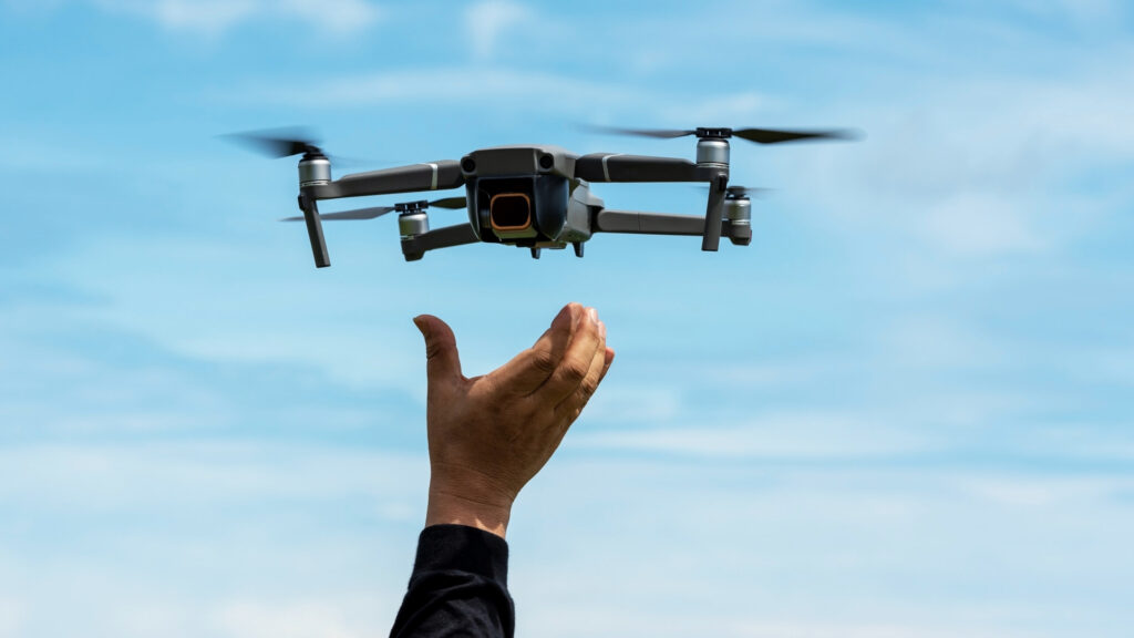 A person launching a drone into the sky, capturing aerial views for adventure photography - Inka Trail Peru.info