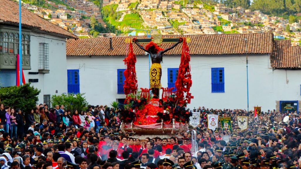 Religious procession of the Lord of the Earthquakes in Cusco with a large crowd and traditional Andean decorations - Inka Trail Peru.info