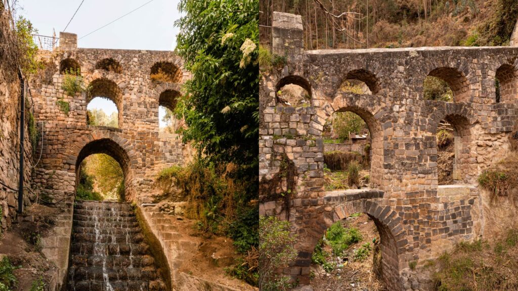 Colonial stone aqueduct bridge of Sapantiana in Cusco with arches and a stepped water channel - Inka Trail Peru.info